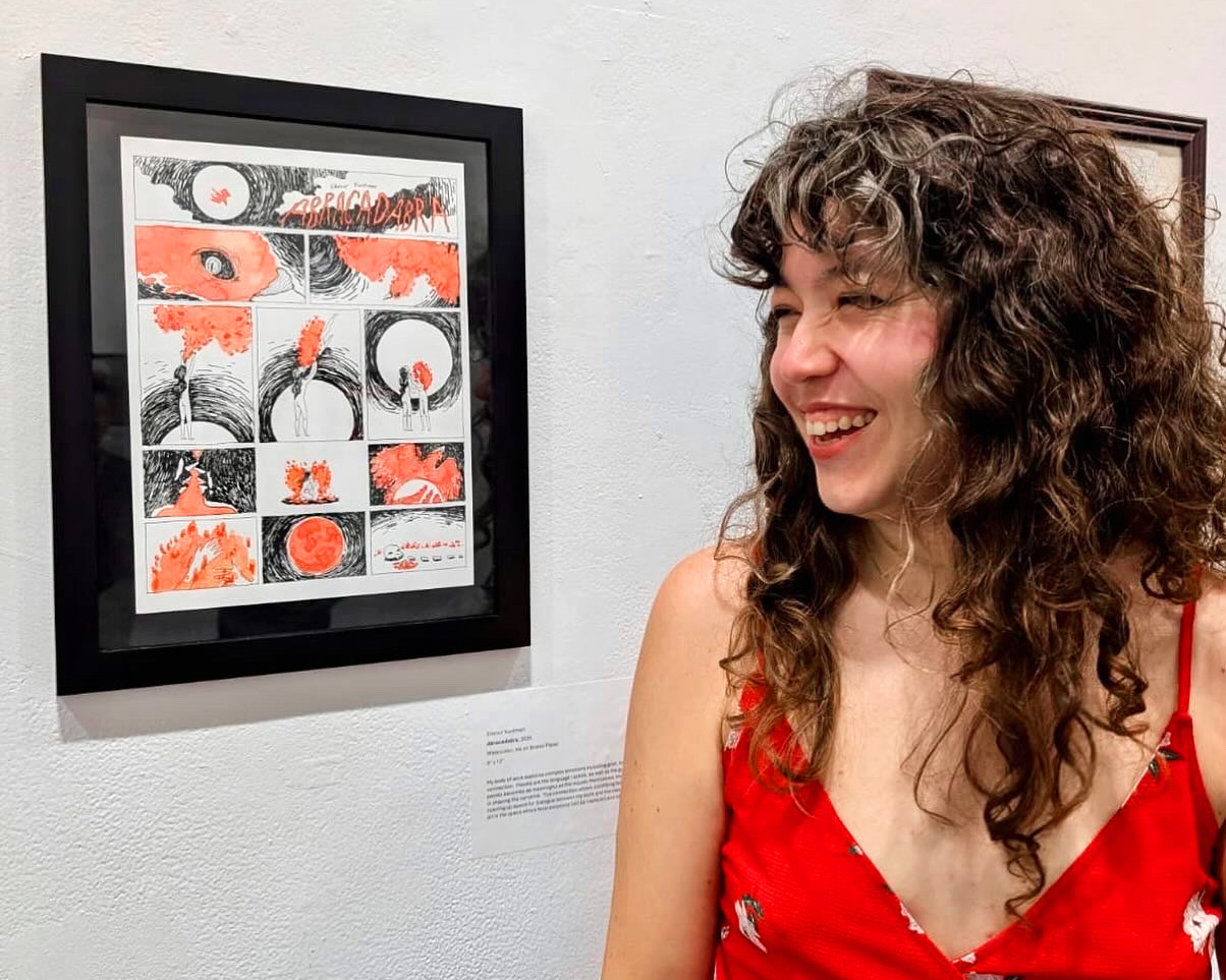 Edanur Kuntman next to the comic Abracadabra at an exhibition